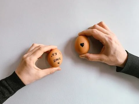Happy Easter or st valentines morning before breakfast. Young couple holding Stock Photos