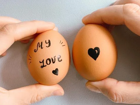 Happy Easter or st valentines morning before breakfast. Young couple holding Stock Photos