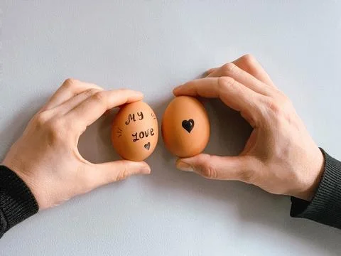 Happy Easter or st valentines morning before breakfast. Young couple holding Foto stock