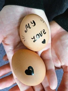 Happy Easter or st valentines morning before breakfast. Young couple holding Foto stock