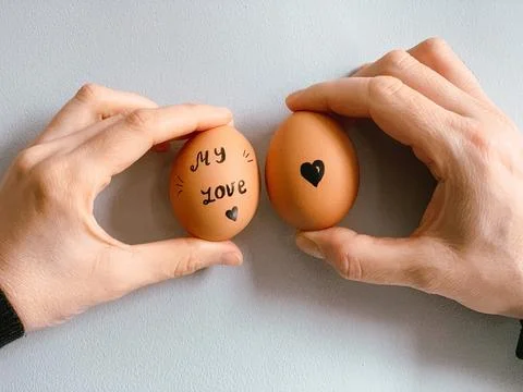 Happy Easter or st valentines morning before breakfast. Young couple holding Stock Photos
