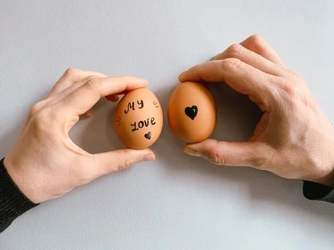 Happy Easter or st valentines morning before breakfast. Young couple holding Stock-Fotos
