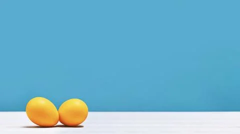 Happy Easter orange dyed eggs on blue banner Stock Photos