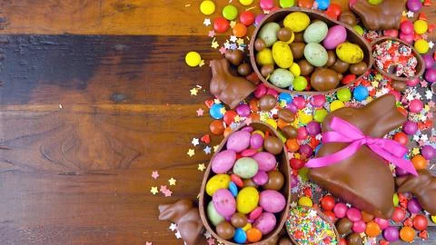 Happy Easter overhead with chocolate Easter eggs and decorations and copy spa Stock Photos