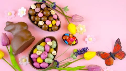 Happy Easter overhead with chocolate Easter eggs and decorations and copy spa Stock Photos