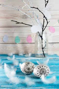Happy Easter. Painted doodle easter eggs on blue background. Stock Photos