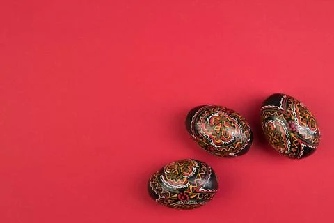 Happy Easter. Painted eggs on red background. Top view. Copy space for text. Stock Photos