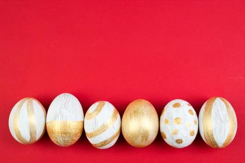 Happy Easter. Painted eggs on red background. Top view. Copy space for text. Stock Photos