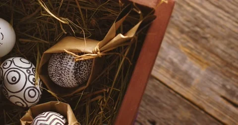 Happy Easter. Painted monochrome stylish eggs on hay in wooden box rotating Stock Footage 150953862
