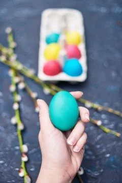 Happy Easter. Painted multi-colored. The girl holds an empty colored egg, a p Stock Photos