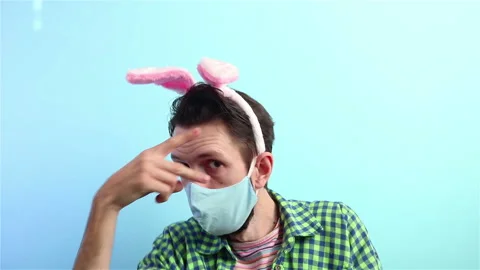 Happy easter party   covid 19 man in face mask and bunny ears having fun dancing Stock Footage 148226531