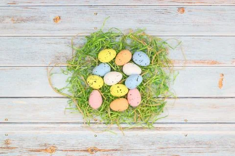 Happy Easter. Pastel colored eggs for Easter in decorated basket 库存照片