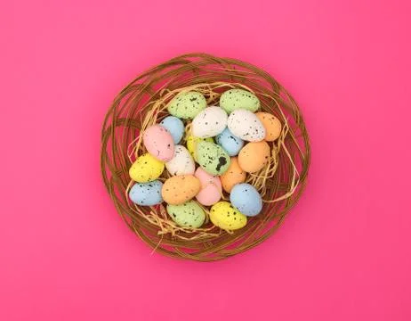 Happy Easter. Pastel colored eggs for Easter in decorated basket 库存照片