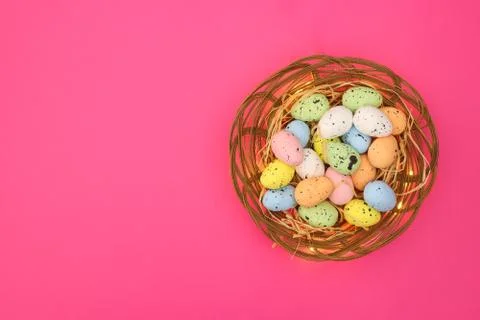 Happy Easter. Pastel colored eggs for Easter in decorated basket 库存照片