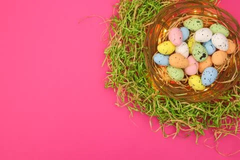 Happy Easter. Pastel colored eggs for Easter in decorated basket Stock Photos