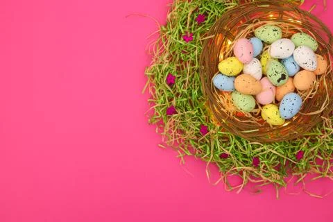 Happy Easter. Pastel colored eggs for Easter in decorated basket Stock Photos