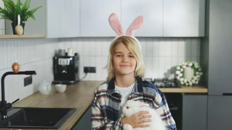 Happy easter. Portrait of the happy blonde boy holding the fluffy easter rabbit Stock Footage 304383995