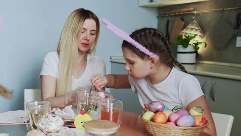 Happy Easter. Preparing the family for Easter. Mother with her daughter paints Stock Footage 151099191