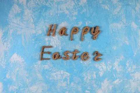 Happy Easter rope typography on the blue textured background. Greeting card. Stock Photos
