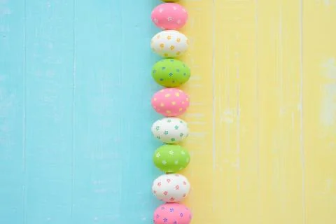 Happy easter! Row Easter eggs with colorful paper flowers on bright blue and Stock Photos