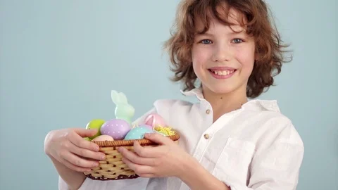 Happy easter. A schoolboy with an Easter basket smiling cheerfully. Portrait on Stock Footage 87866131
