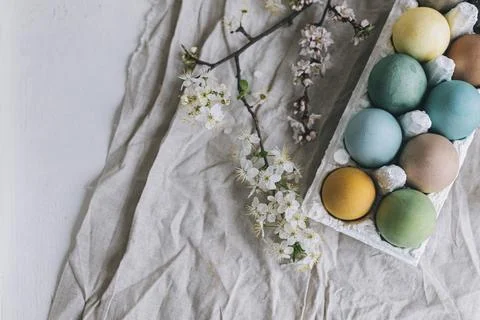 Happy Easter! Stylish Easter eggs and cherry blossoms on rustic linen cloth.. Stock Photos