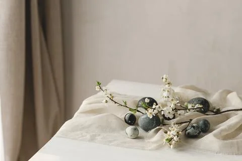 Happy Easter! Stylish easter eggs and spring flowers on linen cloth on rust.. Stock Photos