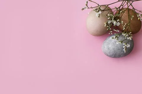 Happy Easter! Stylish eggs and flowers flat lay on pink background. Modern .. Stock Photos