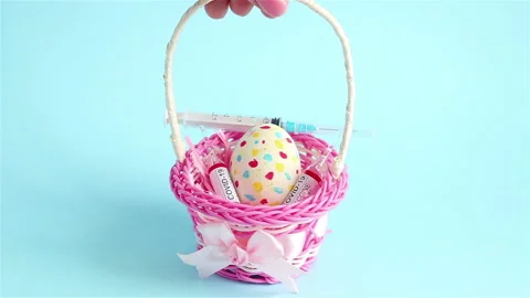 Happy easter   syringe  covid 19 vaccine ampoule egg in wicker basket Stock Footage 147867215