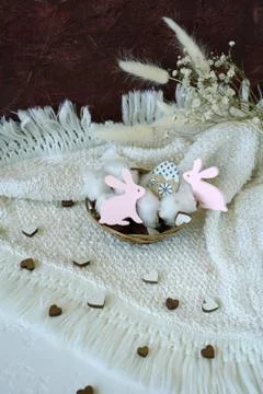 Happy Easter table with pink rabbits, eggs, hearts in pastel colors Stock Photos