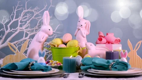 Happy Easter table setting with pink bunny and Easter Eggs centerpiece Stock Footage 71692755