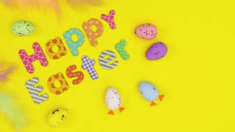 Happy Easter text and moving eggs on yellow theme. Stop motion Stock Footage 149265008