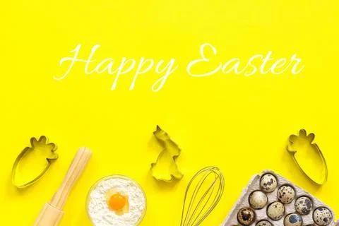 Happy Easter text and rolling pin, whisk for whipping, cookie cutters, quail Stock Photos