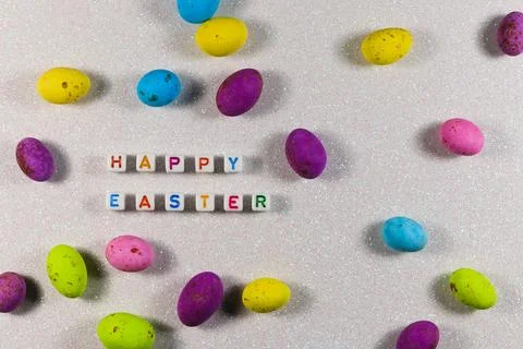 Happy Easter Text Beads With Candy Eggs Layout Stock Photos