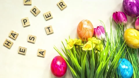 Happy Easter text with colorful paineted easter eggs in fresh green grass Stock Footage 236007756