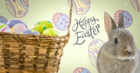 Happy Easter text with Easter Rabbit with eggs basket in front of pattern Stock Fotos