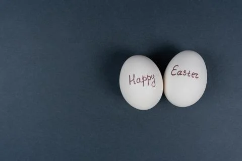Happy Easter text on white eggs isolaed on grey background. Easter holiday Stock Photos