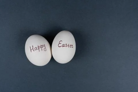 Happy Easter text on white eggs isolaed on grey background. Easter holiday Stock Photos