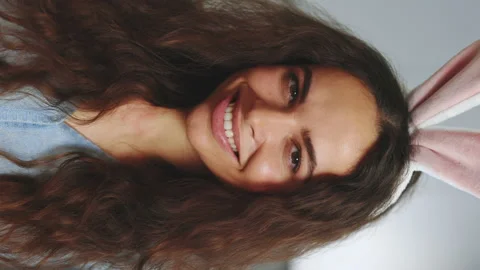 Happy easter. Vertical video. Portrait beautiful woman wearing bunny ears Stock Footage 232057106