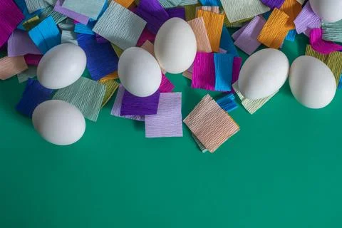 Happy Easter. White eggs with colored crepe paper on green background with .. Stock Photos