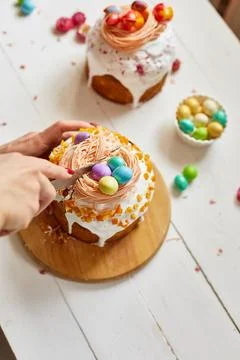 Happy Easter, Woman cut Easter cake for the holiday Stock Photos