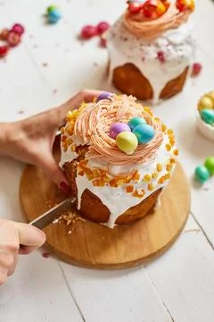 Happy Easter, Woman cut Easter cake for the holiday Stock Photos