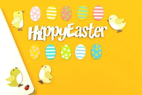 Happy Easter workspace concept with festive decorations Stock Photos