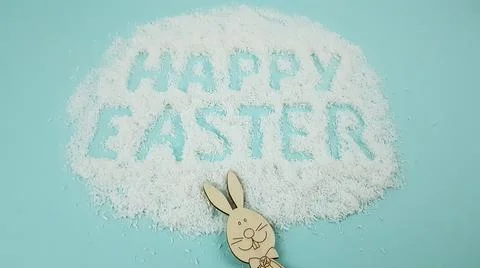 Happy Easter is written on a light blue background. easter bunny and ears are Stock Photos
