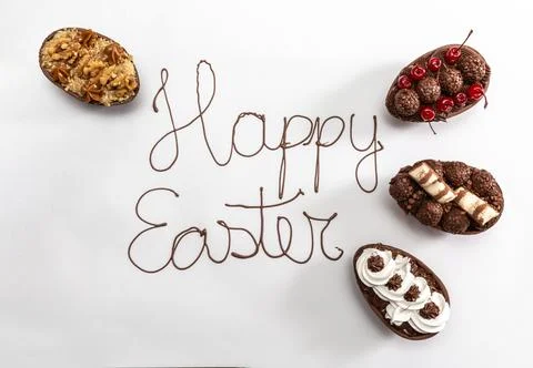 "Happy Easter" written with melted chocolate on white background. With gour.. Stock Photos