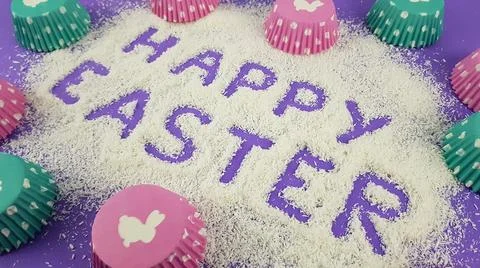 Happy Easter is written on a purple lilac background. according to Pantone, t Stock Photos