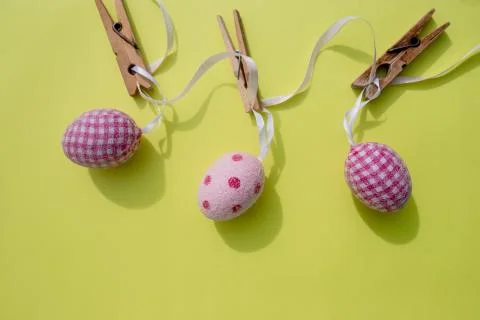 Happy Easter.Greeting card with easter eggs hanging on clothesline, yellow Stock Photos