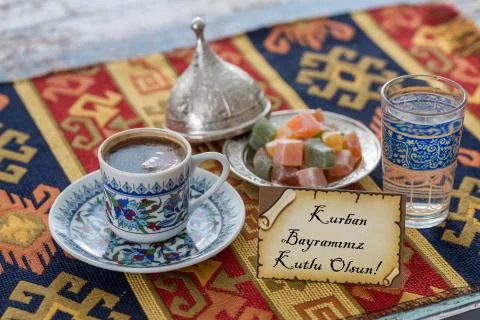 Happy eid al adna text in turkish on greeting card with turkish coffee, delig Stock Photos