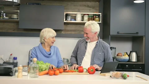 Happy elder couple having fun and singing at the kitchen. Stock Footage 102434553