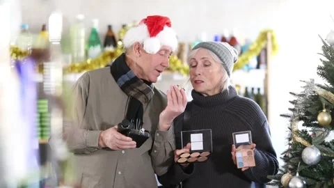 Happy elderly couple choosing cosmetics and perfume in supermarket before Stock-Footage 307146893